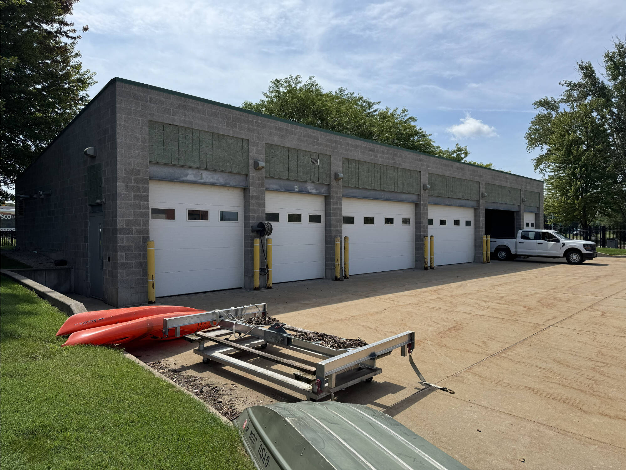 The AWRI fleet garage, with a work truck, kayak, and small boat on display.
